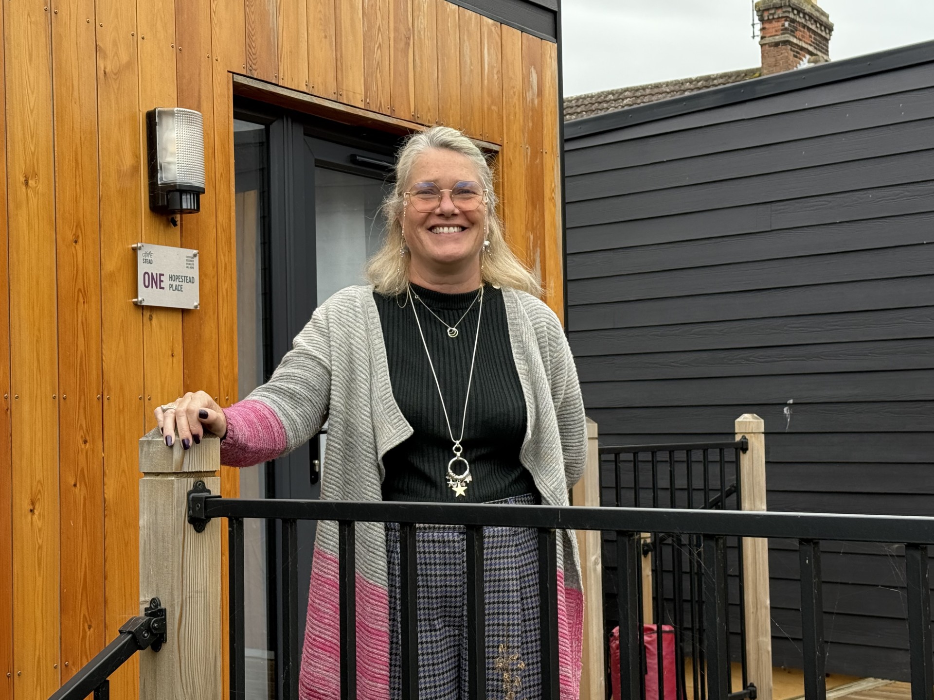Person on front porch smiling