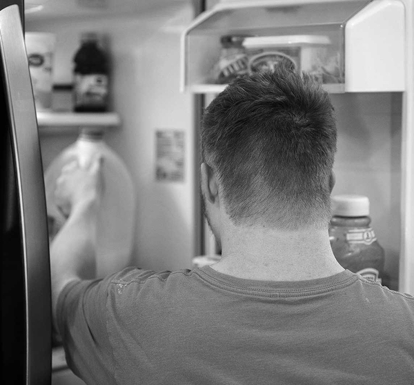 Person putting items in fridge