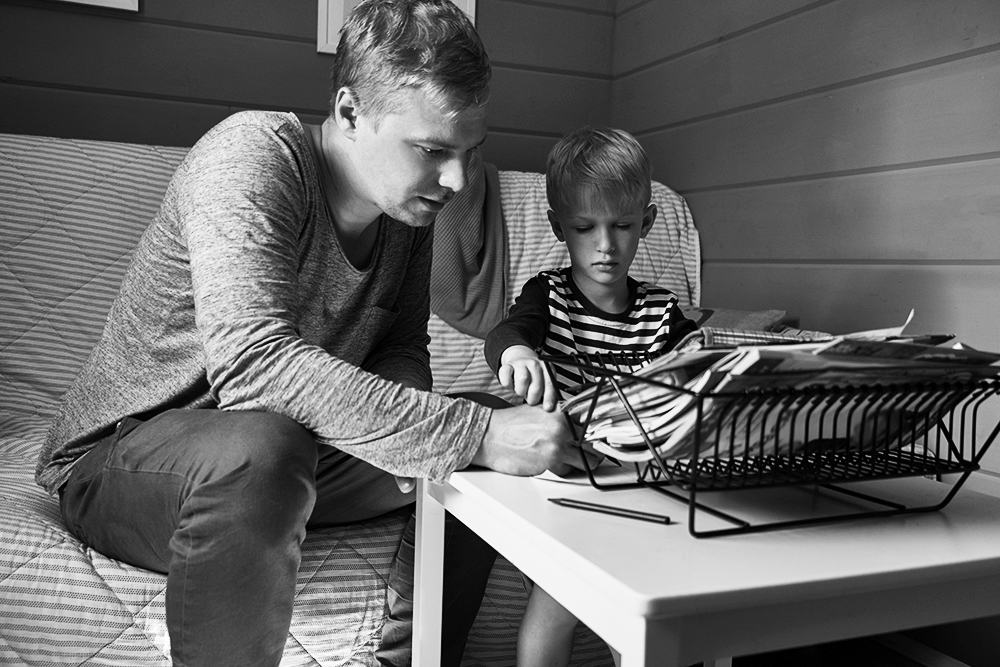 Parent and child looking at magazines