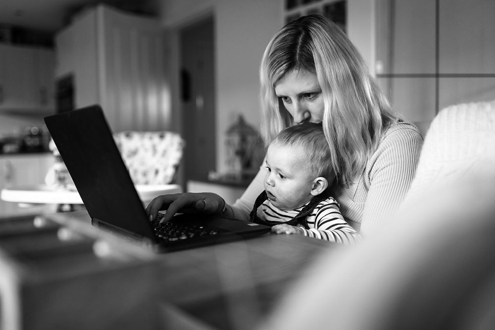 Parent and baby looking at laptop